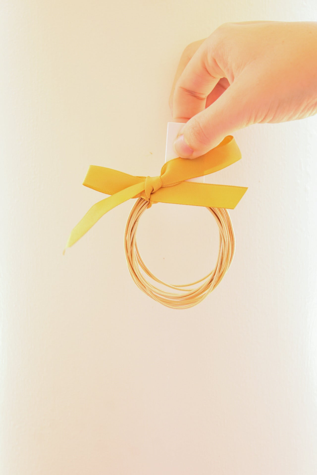 Golden Stella 12-row piano wire bracelet featuring sleek, interconnected metal strands in a stylish, modern design.