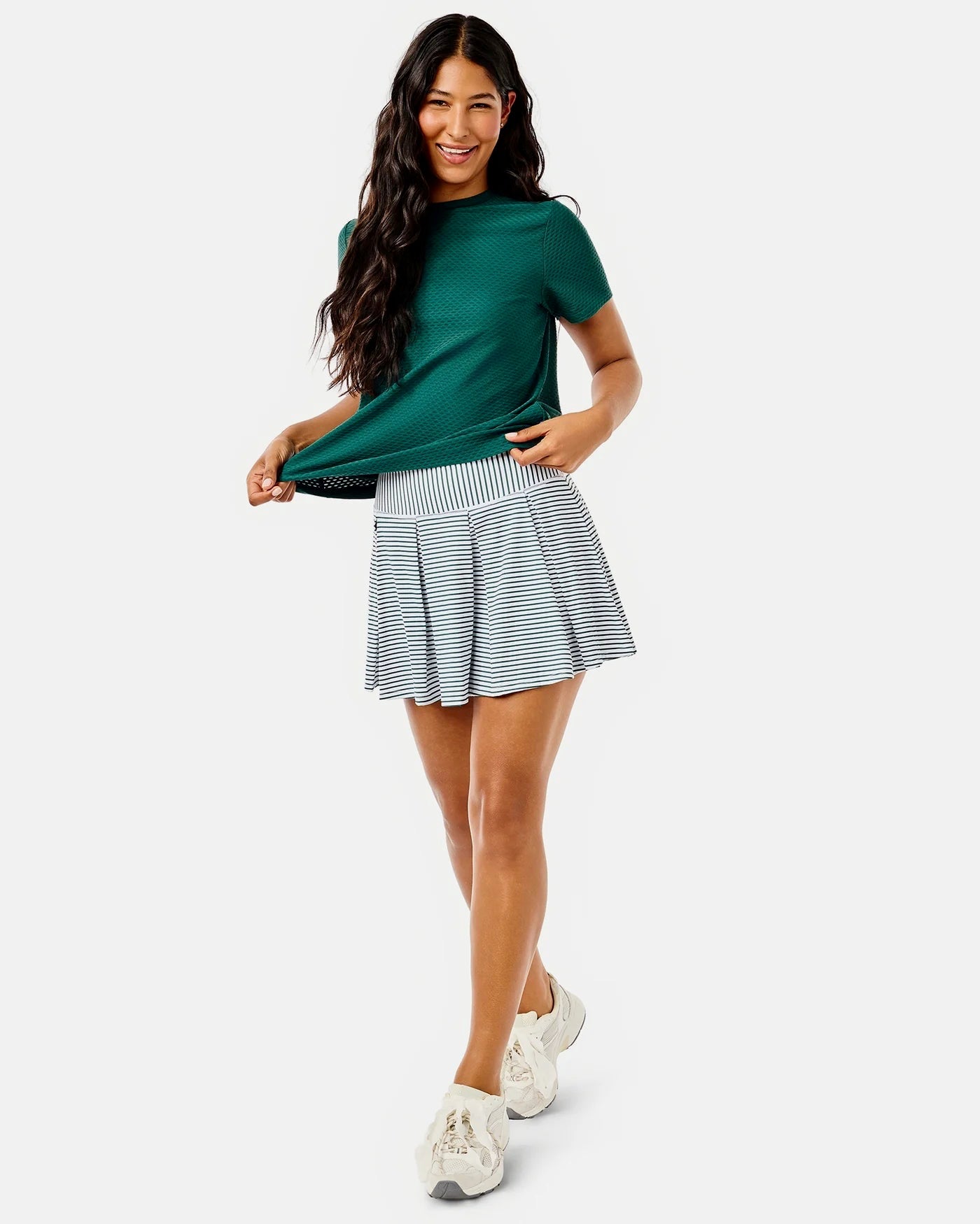 ADDISON BAY racquet skort in super white and ivy stripe, showing the athletic skirt with built-in shorts and tennis-inspired design.