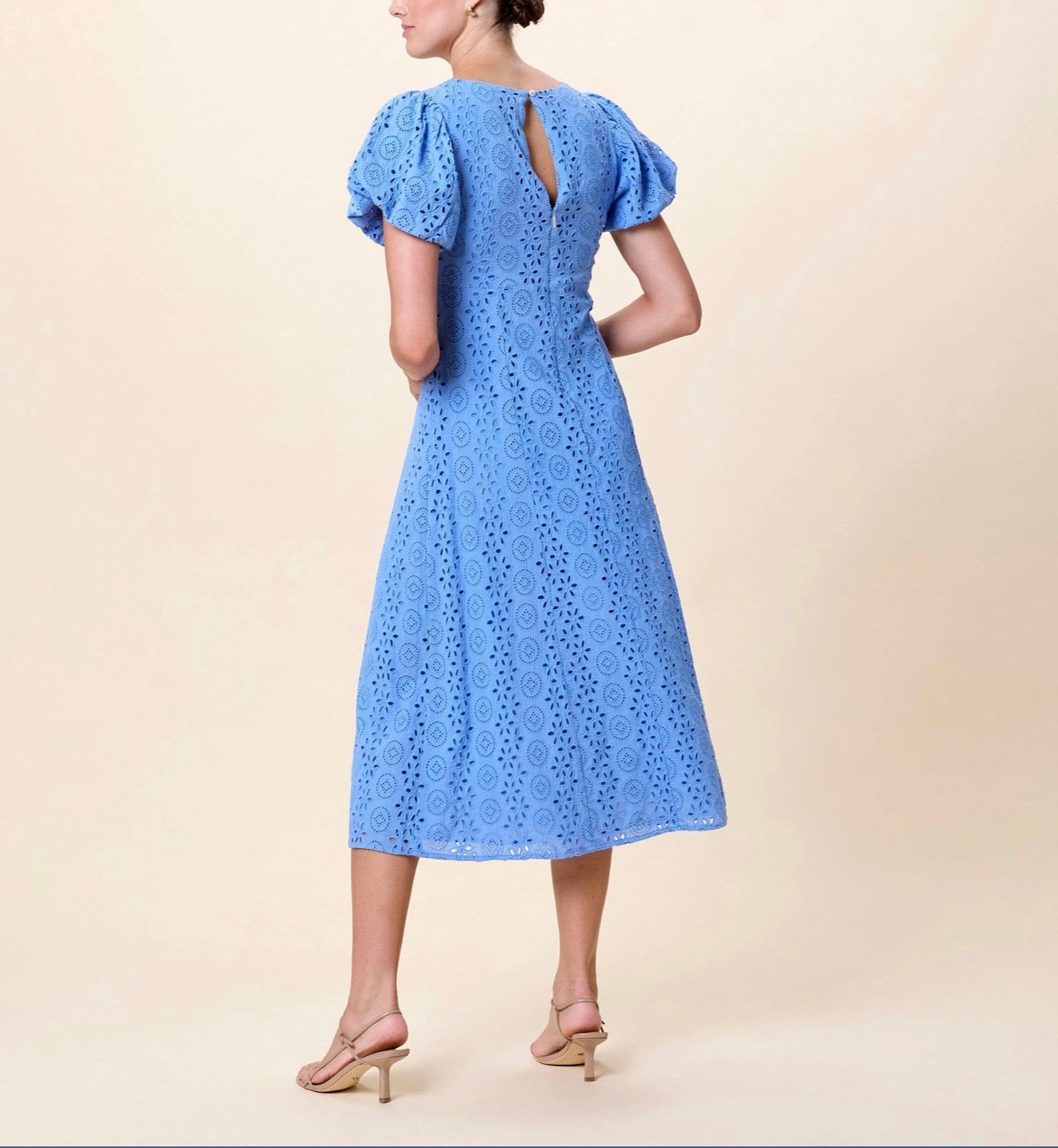 Leslie Midi Dress by CLEOBELLA in Blue Bonnet color, featuring a flowing silhouette and elegant design, displayed on a hanger.