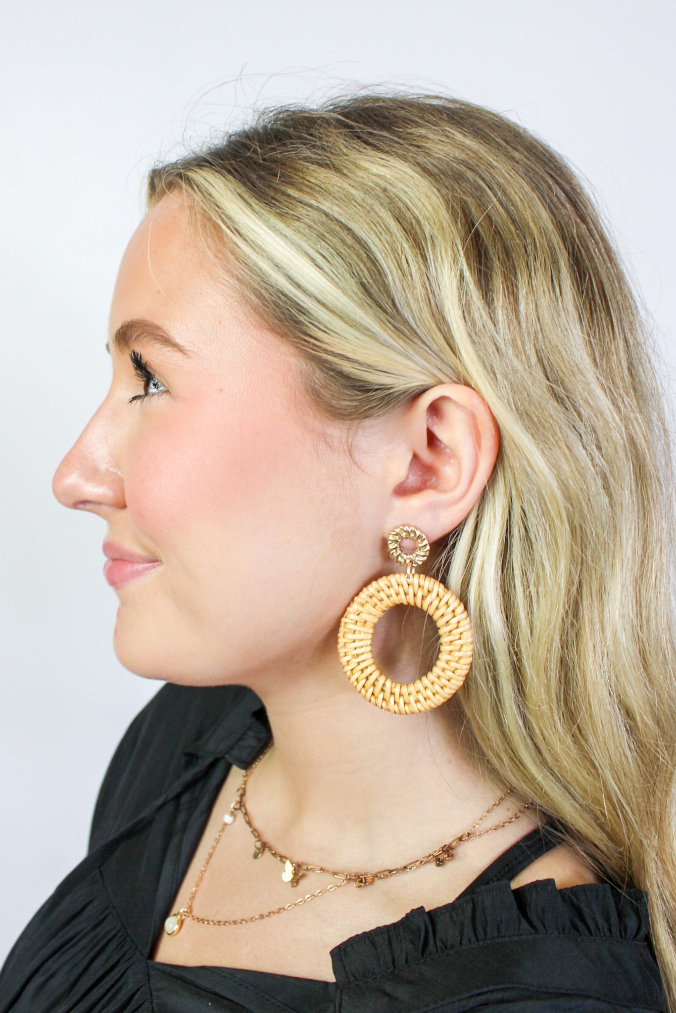 Golden Stella rattan circle drop earrings featuring round woven rattan design and gold-tone hooks for a stylish jewelry accessory.