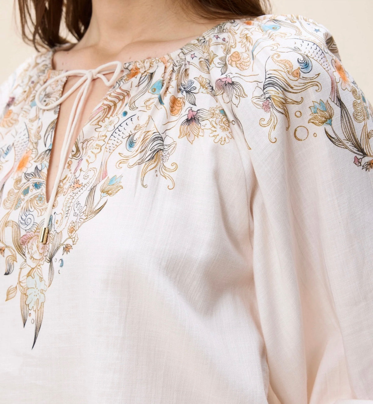 Issey Top by CLEOBELLA displayed on a hanger, featuring a stylish, sleeveless design with a fitted silhouette and neutral color.