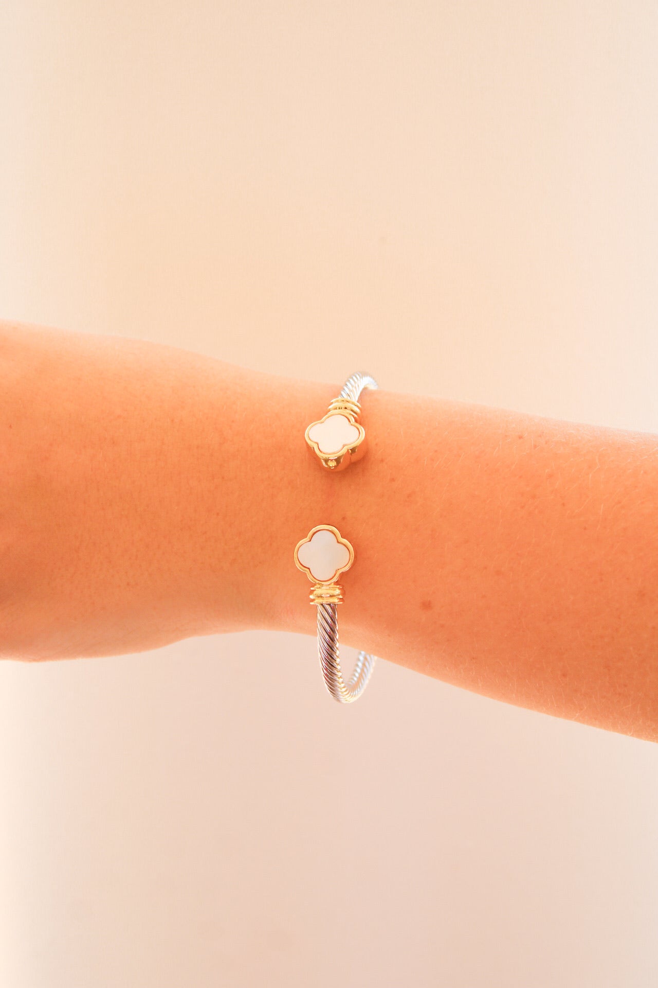Golden Stella epoxy clover cable cuff bracelet featuring a sleek, modern design with a polished finish and intricate cable details.