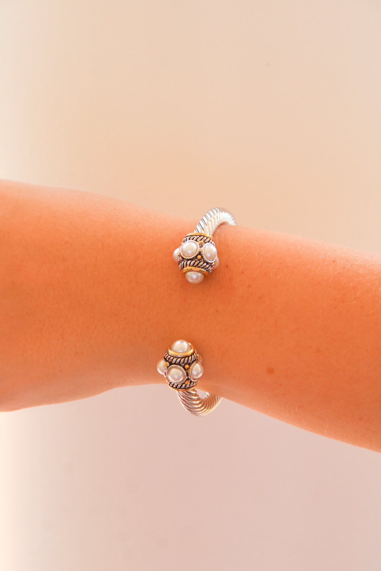 Golden Stella paved ball cable cuff bracelet featuring a sleek silver design with small decorative ball accents.
