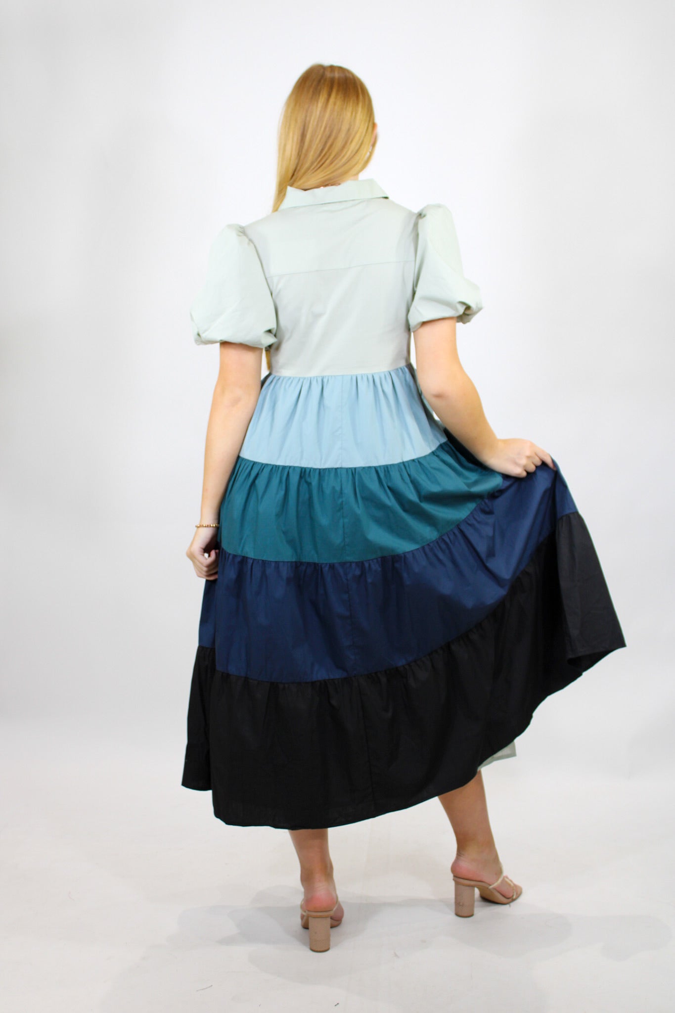 AUREUM Cold Weather Blues Dress displayed on a hanger, featuring a stylish, long-sleeve design suitable for chilly weather.