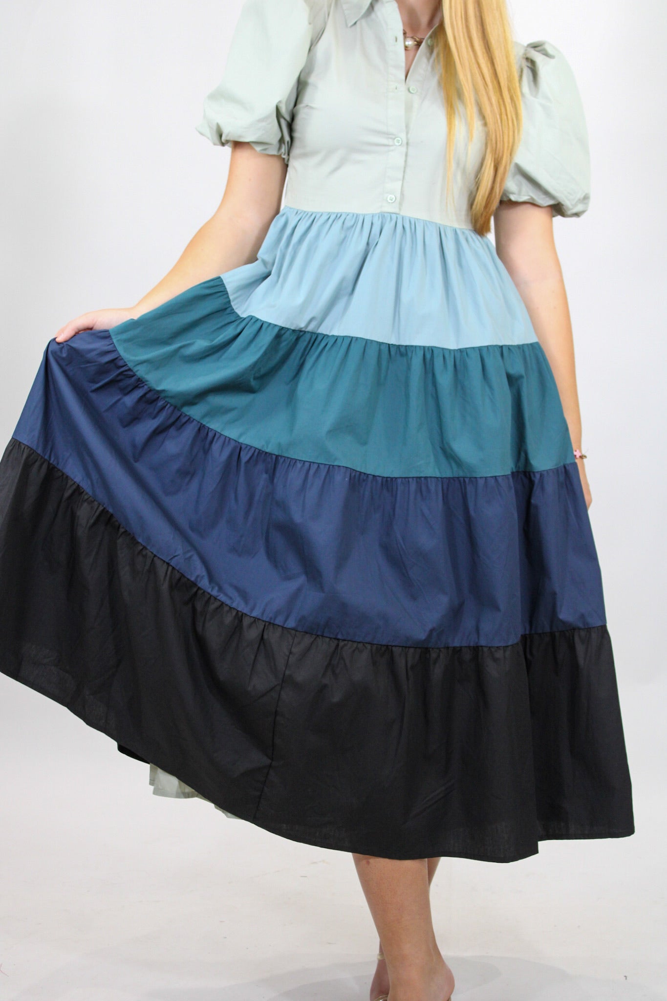 AUREUM Cold Weather Blues Dress displayed on a hanger, featuring a stylish blue dress suitable for cooler seasons.