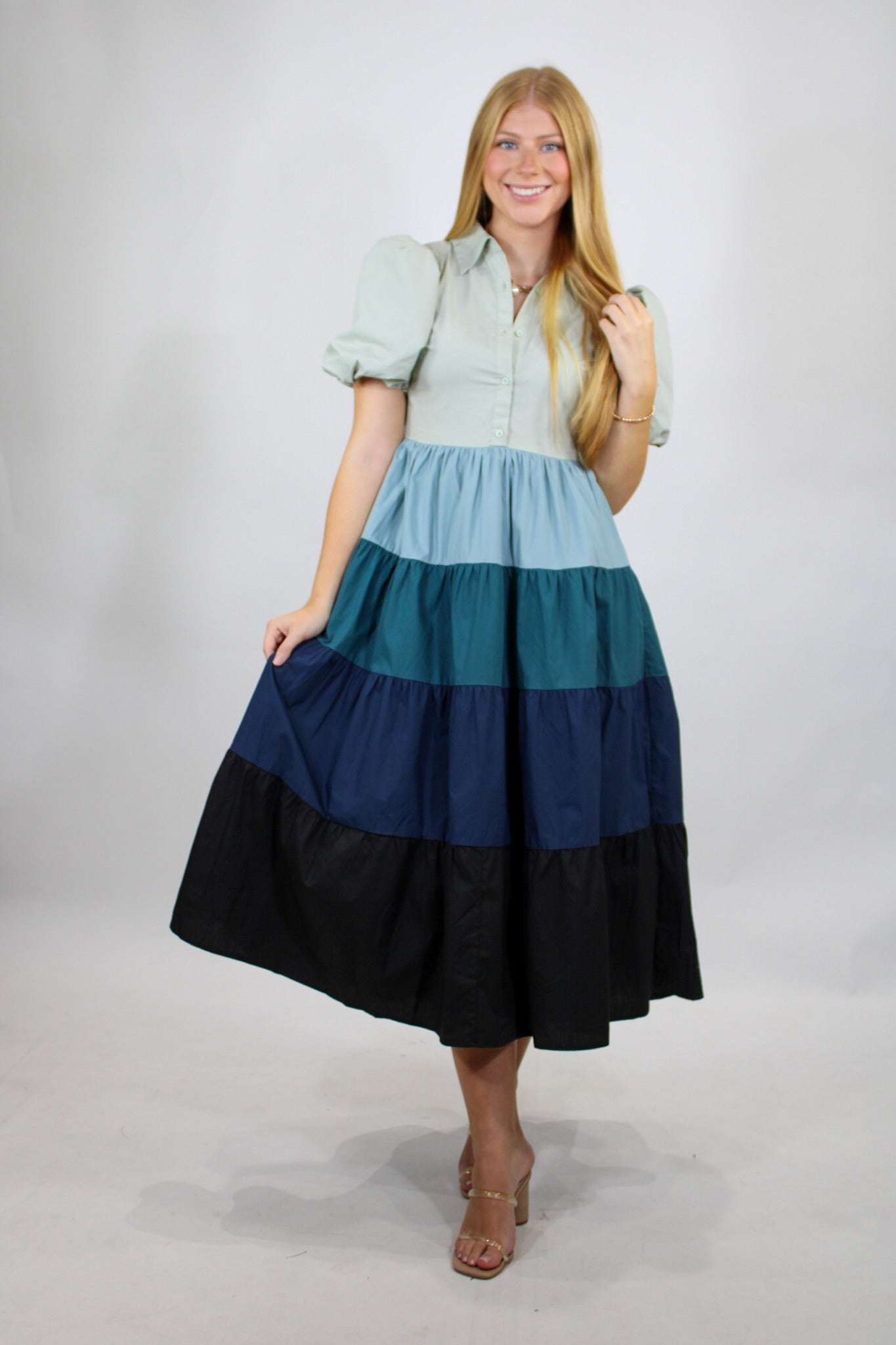AUREUM Cold Weather Blues Dress featuring long sleeves, a fitted silhouette, and a stylish blue fabric perfect for winter wear.