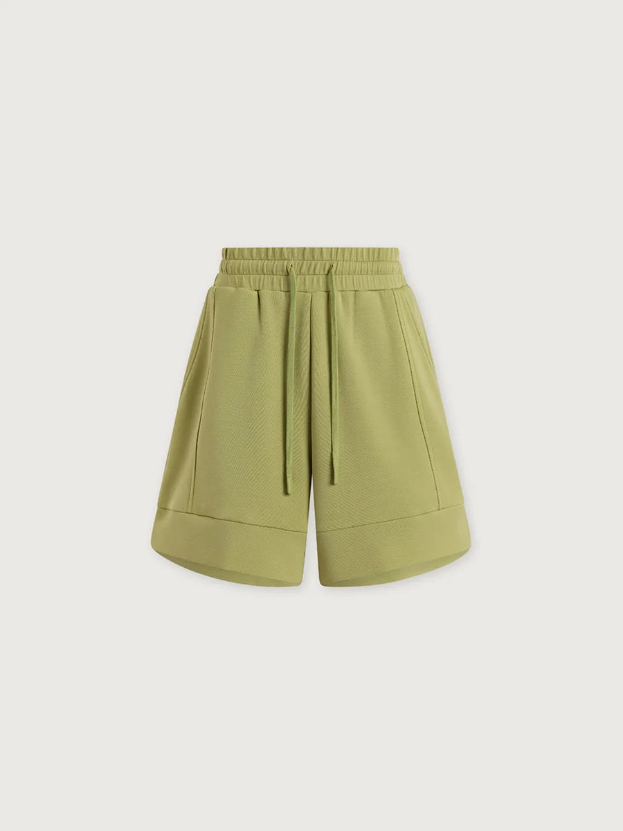 Varley Atrium High Rise Short 4.5 in Fern, showcasing lightweight fabric and high-waisted design with a relaxed fit.