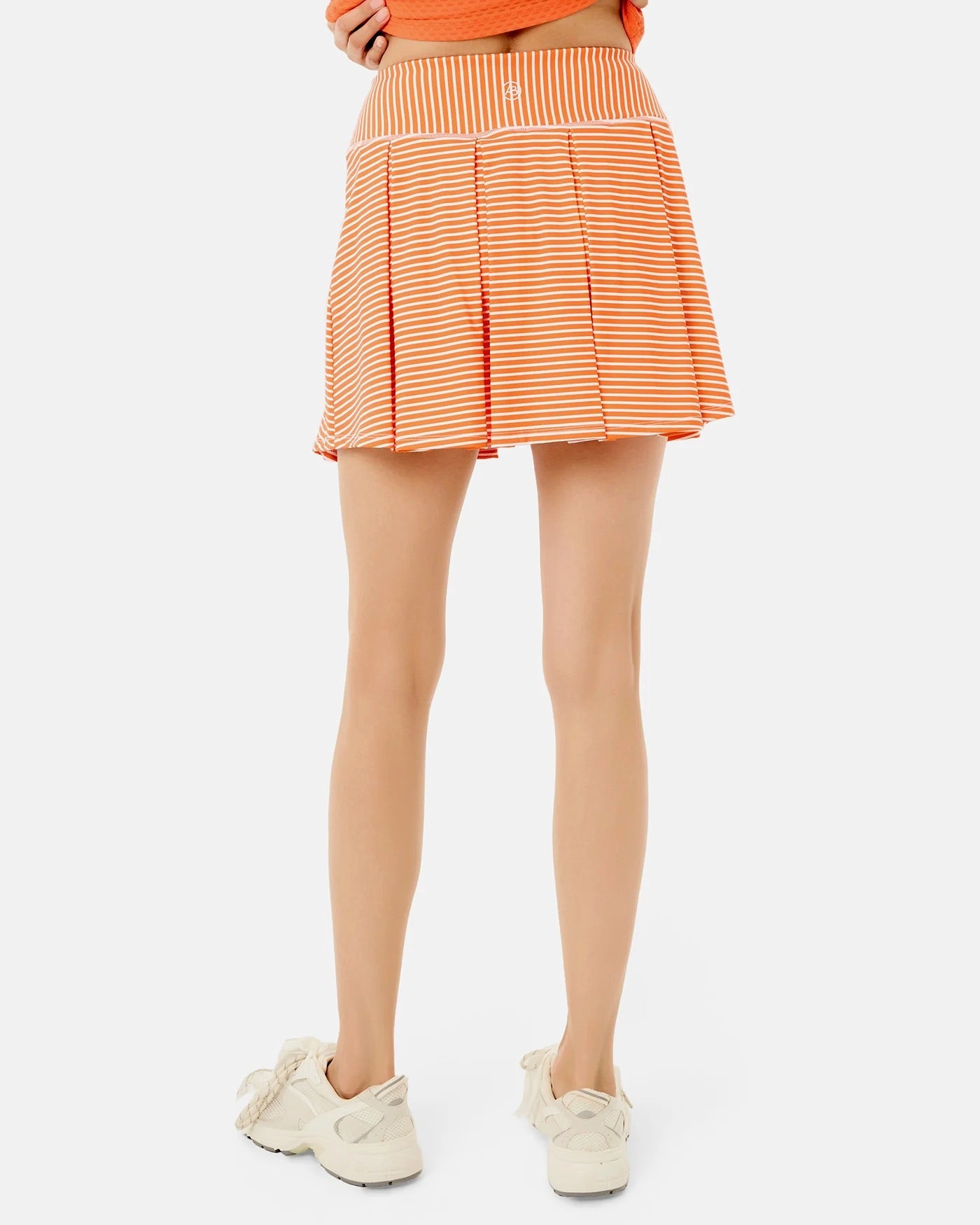 ADDISON BAY racquet skort in Super White and Papaya Stripe, with a lightweight design and sporty style for active wear.