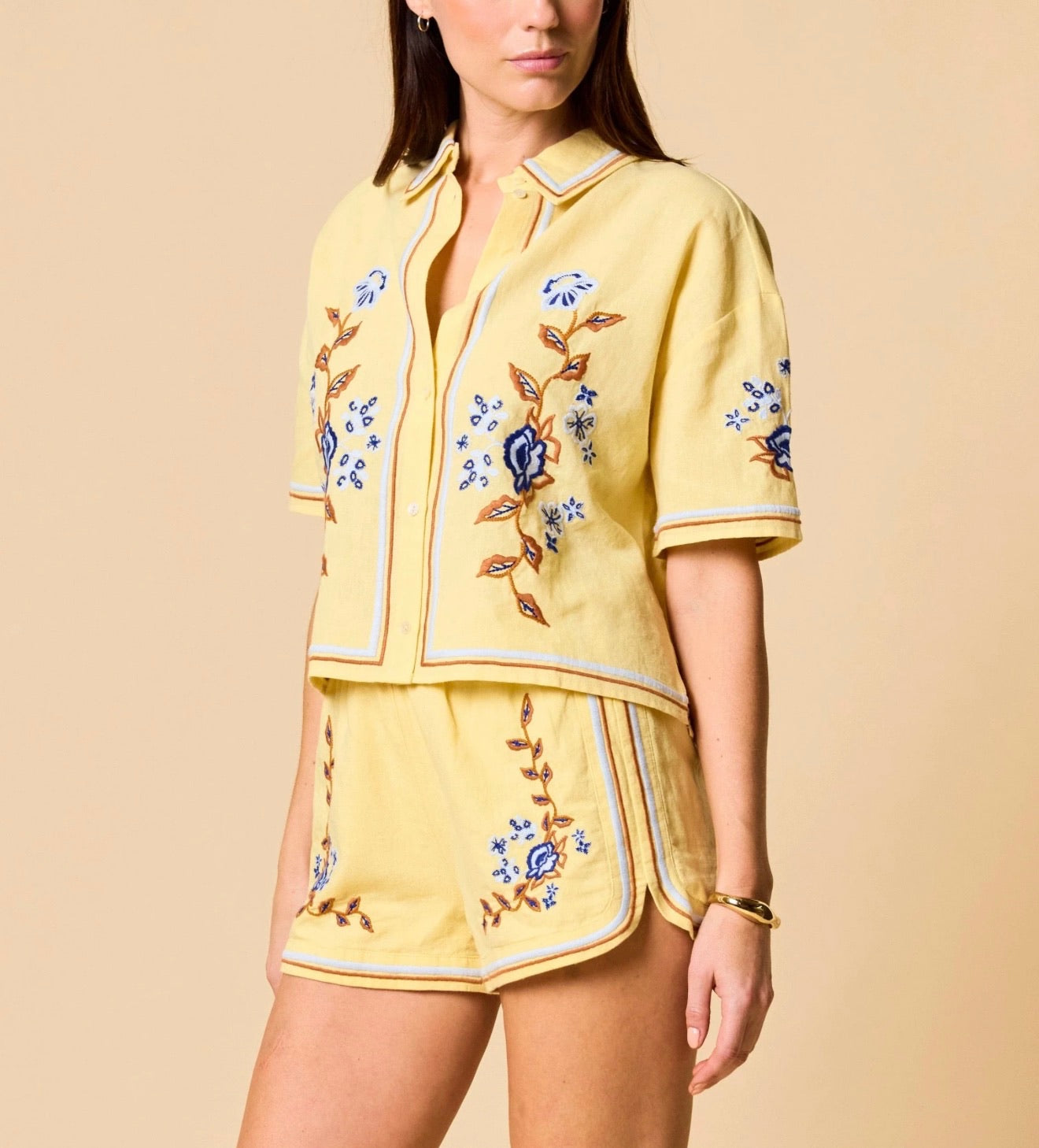 Wynona Top by CLEOBELLA featuring a stylish, lightweight design with a V-neck and short sleeves, displayed on a hanger.