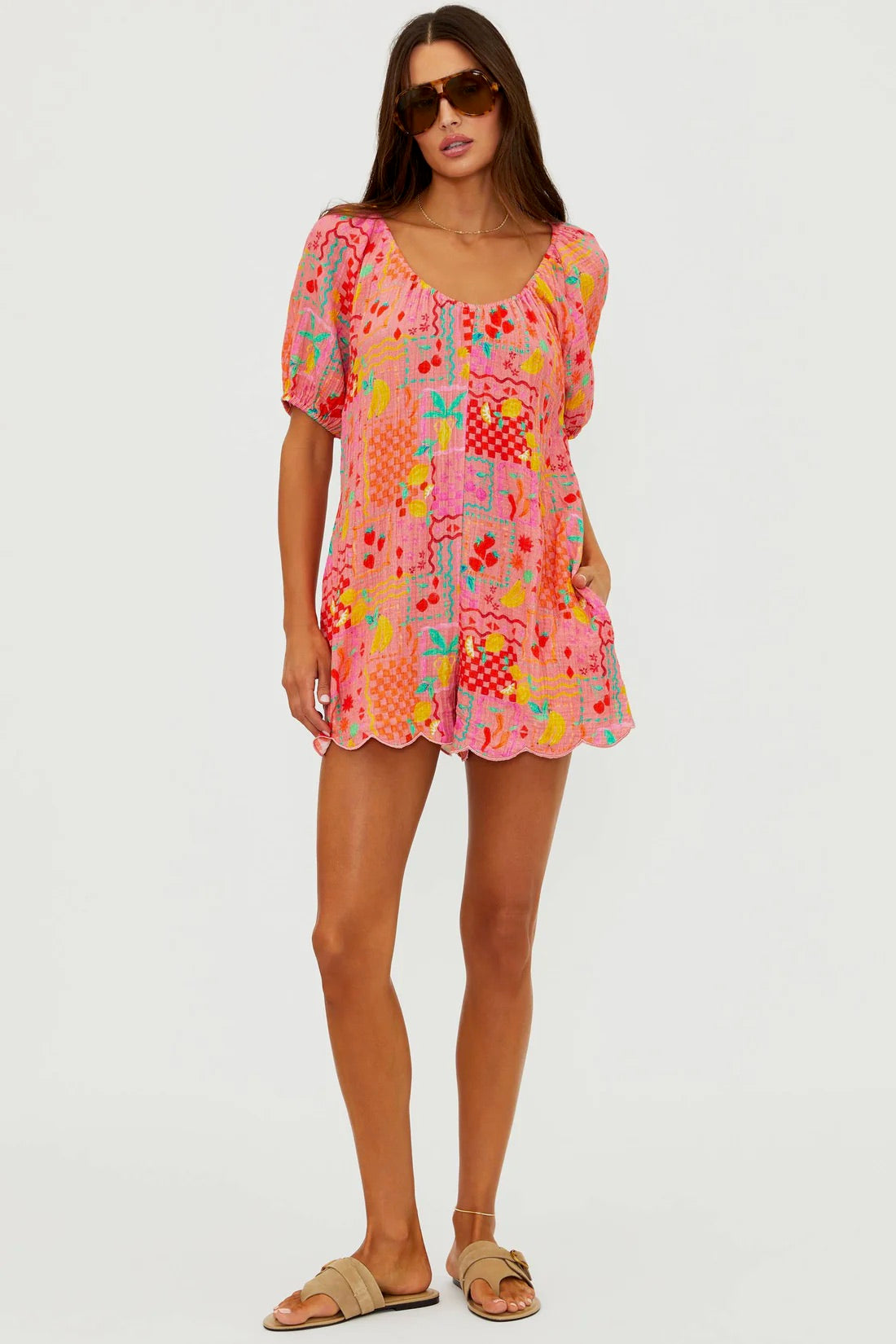 BeachRiots Ellery Romper in Passion Fruit displayed on a model, featuring vibrant tropical print and lightweight fabric for summer wear.