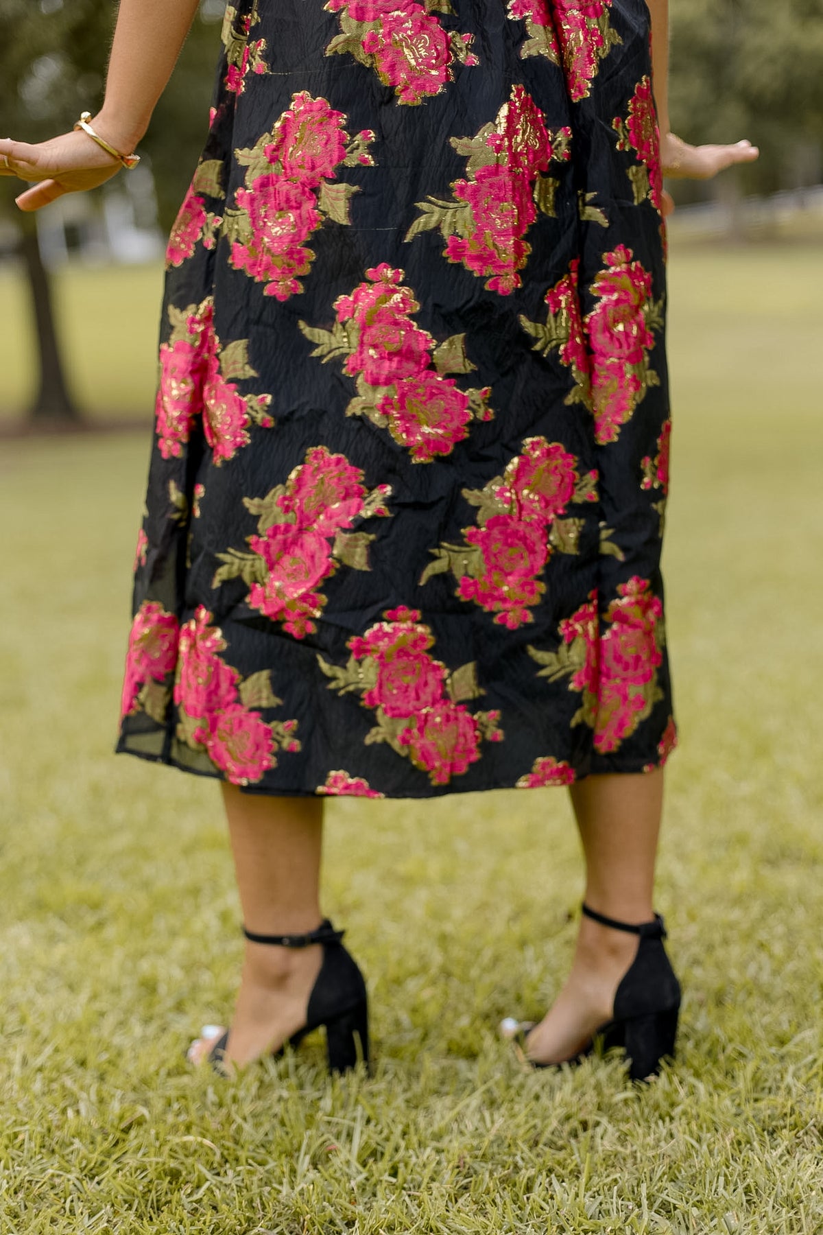 Shopsisterology Poinsettia Midi Dress with floral pattern, V-neckline, and long sleeves, displayed on a hanger.
