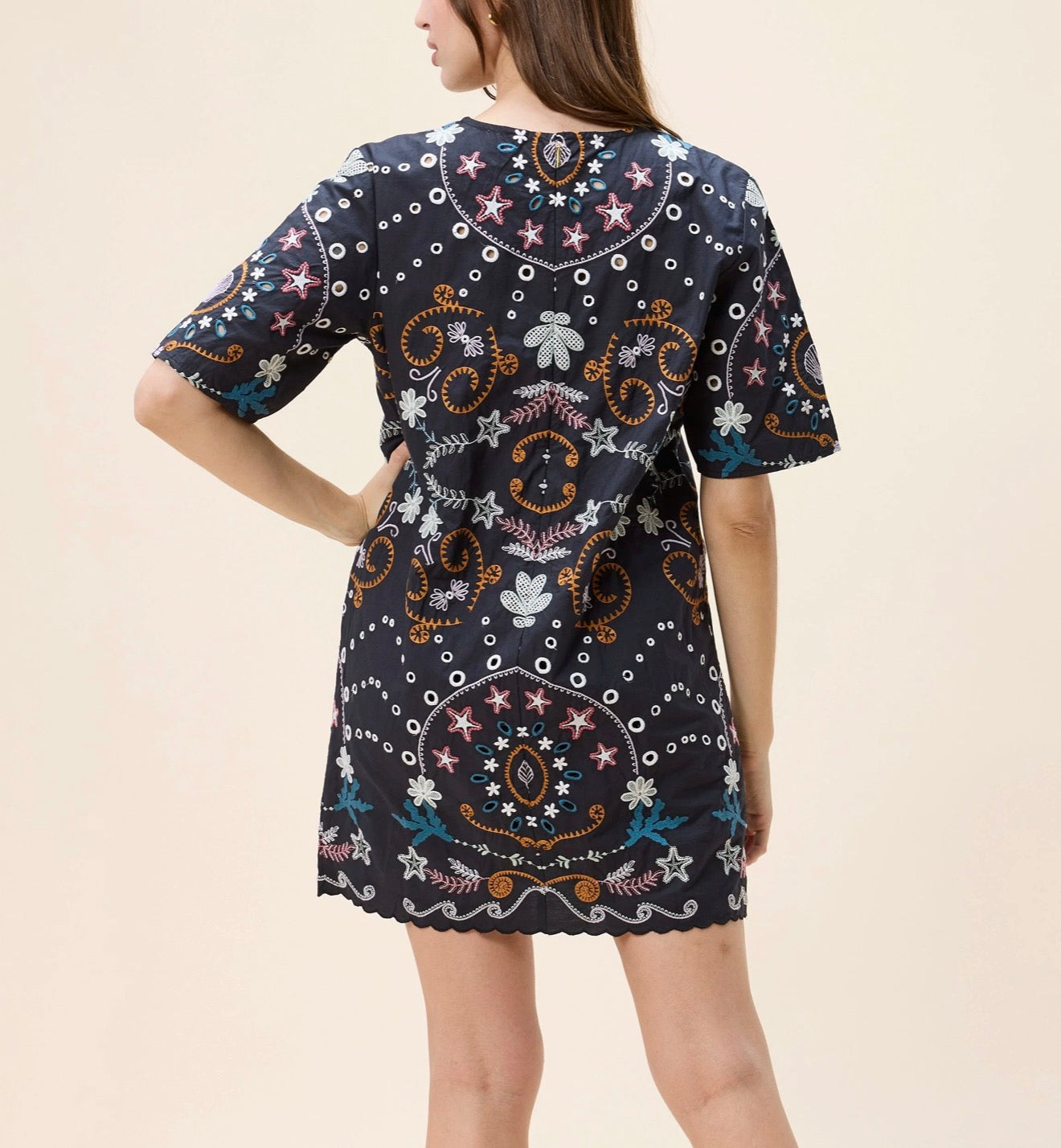 Black Mische mini dress by CLEOBELLA displayed on a hanger, showcasing its sleek, fitted design and stylish short length.