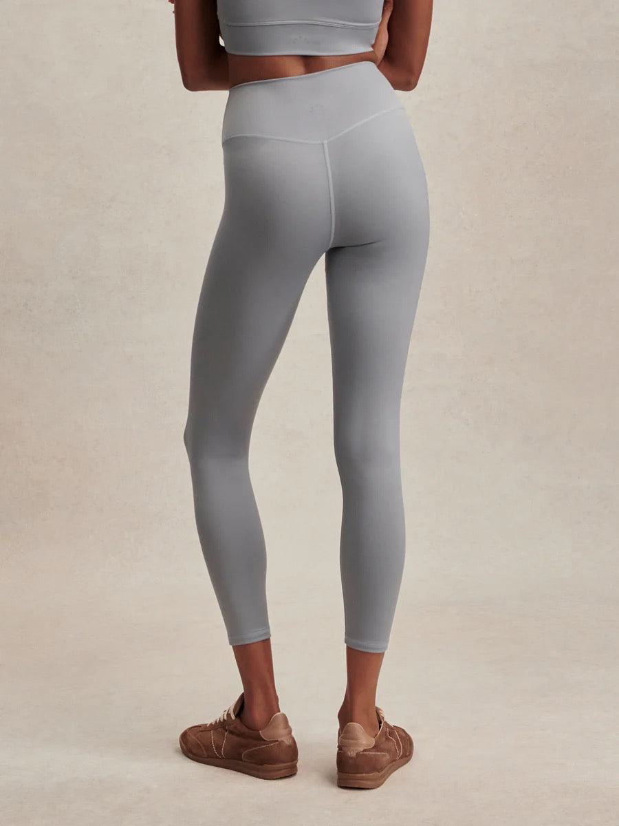 Varley Assure High Rise Legging 25 in Wind Blue, close-up of the fitted athletic leggings showing textured fabric and high waist design.