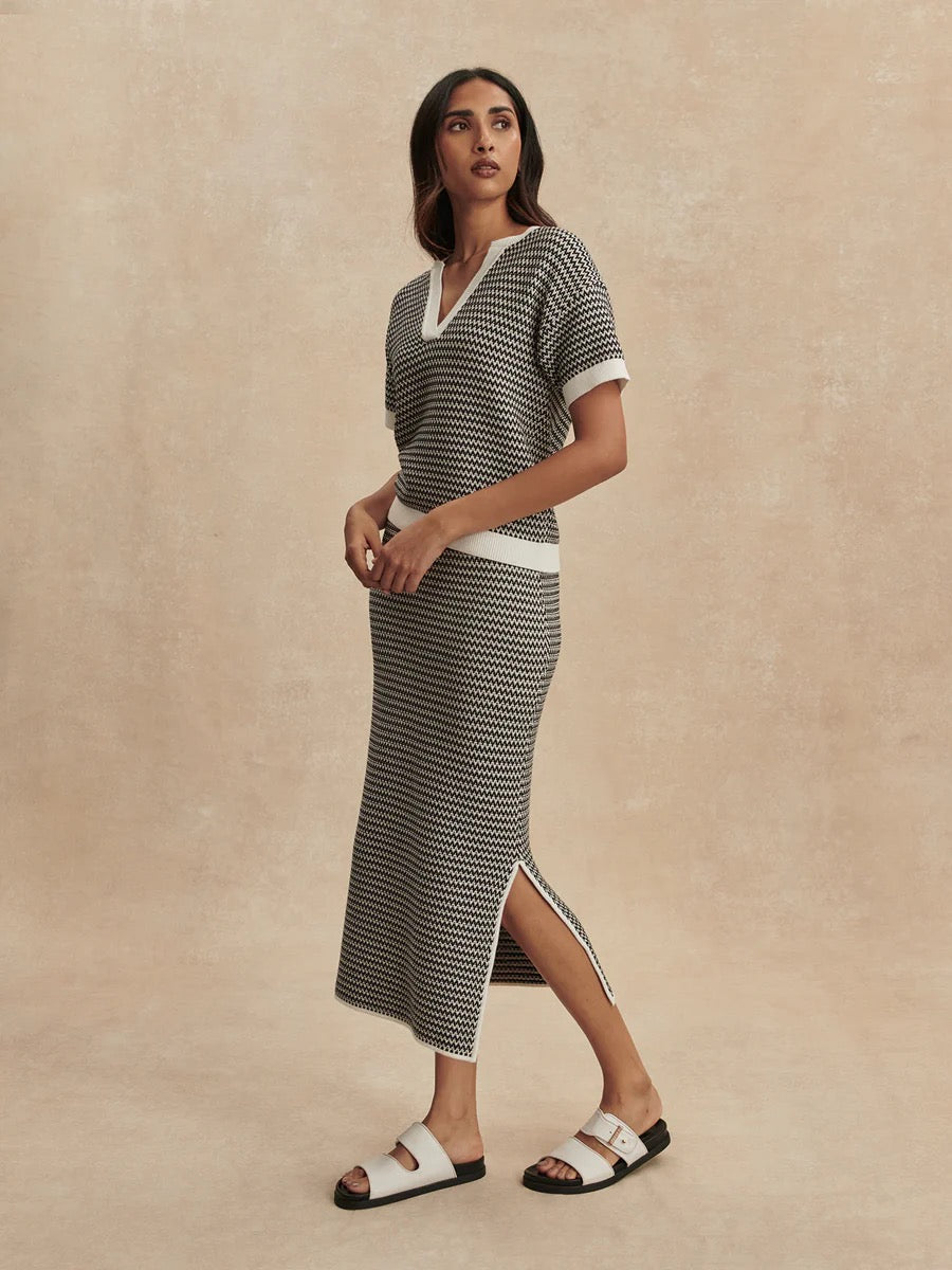 Varley Dora Knit Top 2.0 in Snow White and Black, featuring a stylish knit design and classic color contrast.