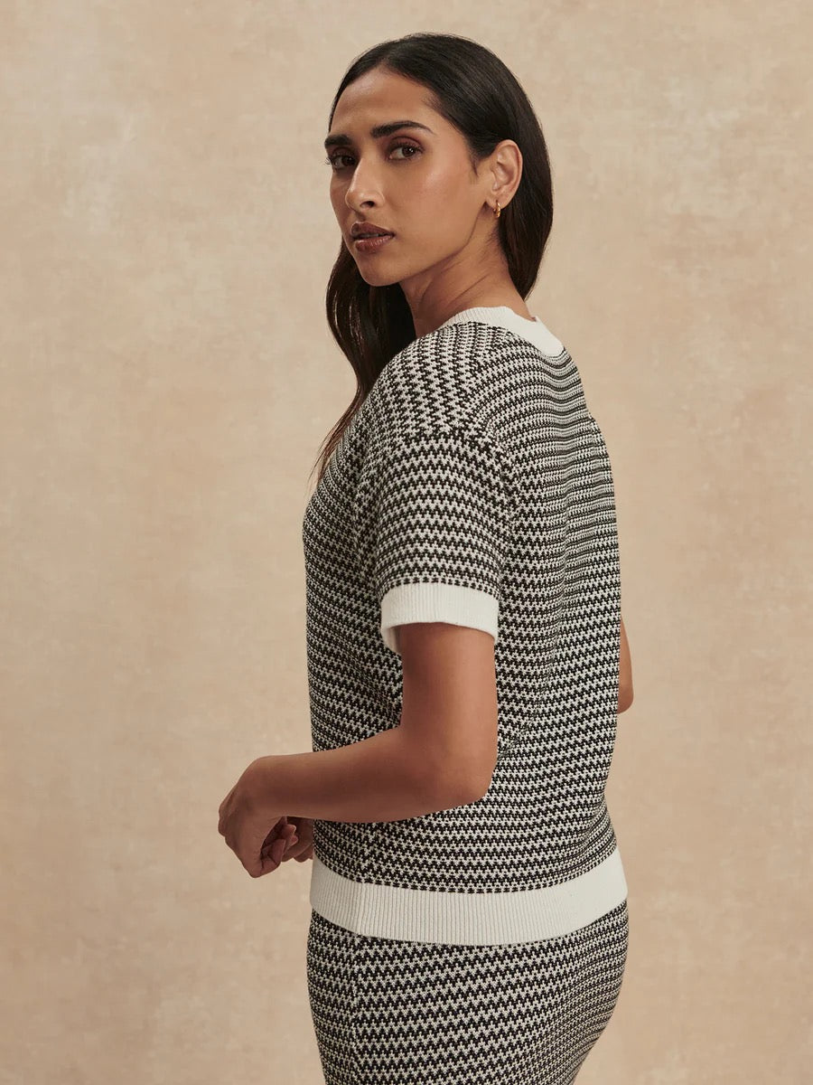 Varley Dora Knit Top 2.0 in snow white and black, featuring a cozy, stylish knit design with a relaxed fit and long sleeves.